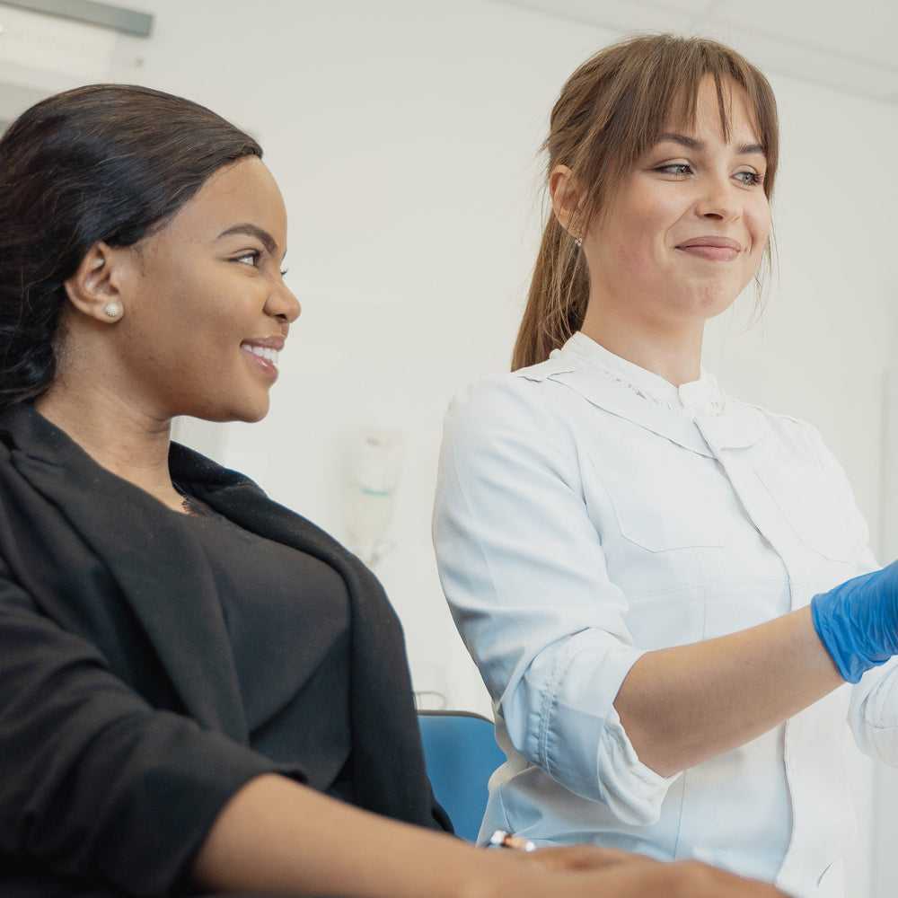 Dental patient smiling at her dentist