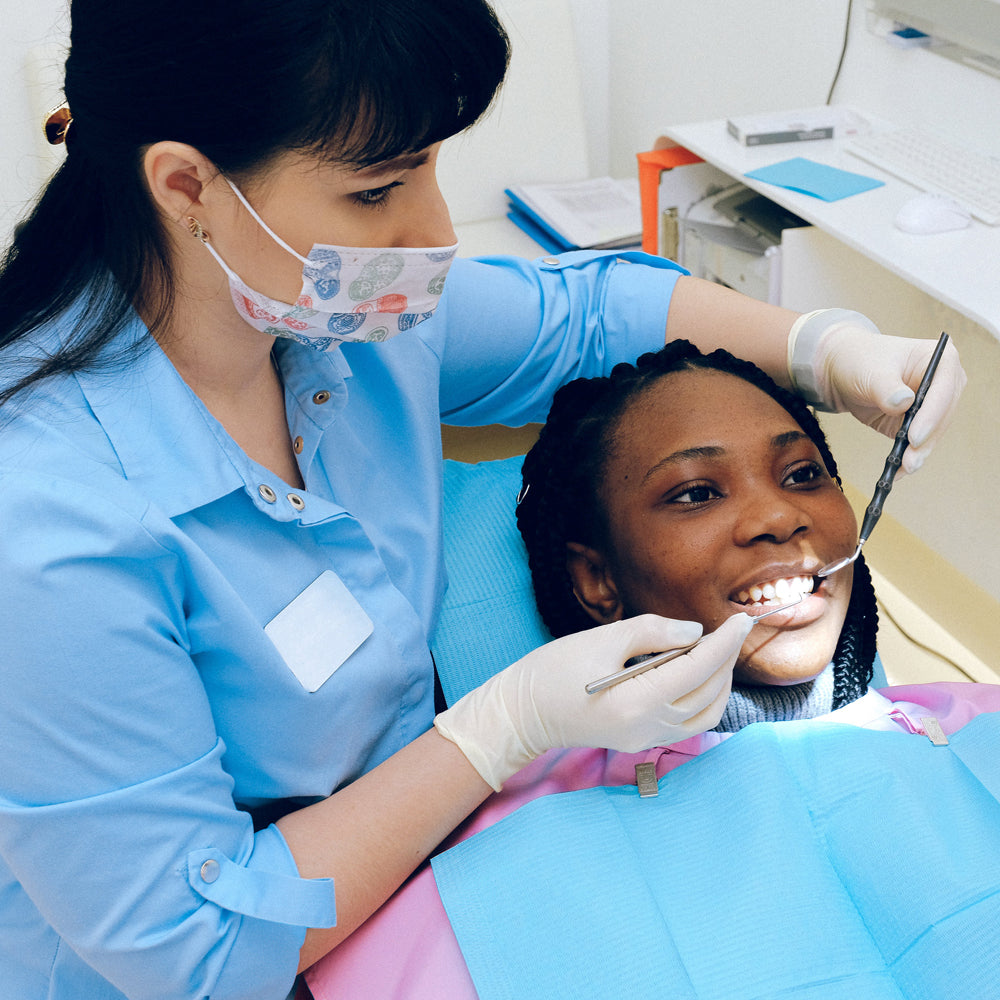 Dentist examining patient's teeth
